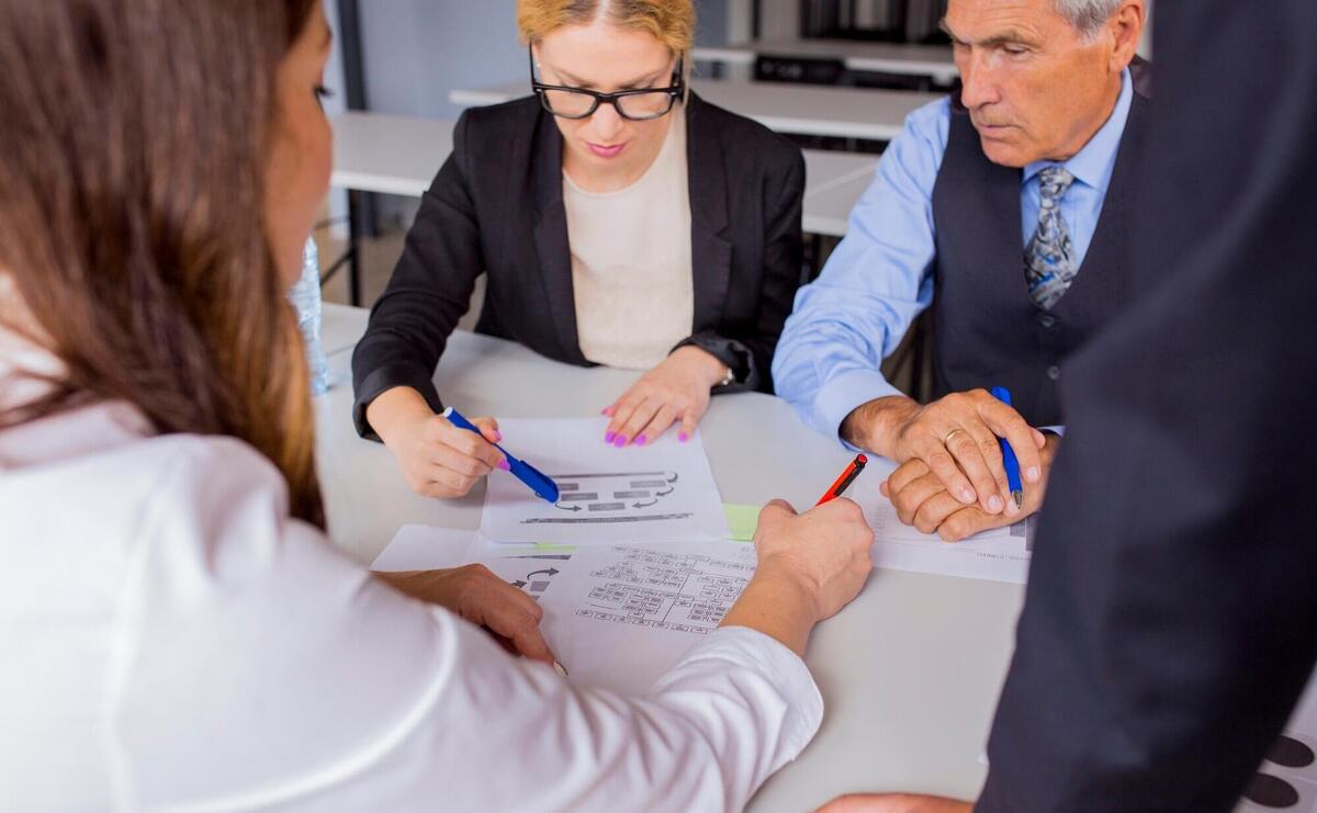 Group of business people discussing the business plan at the table in the office