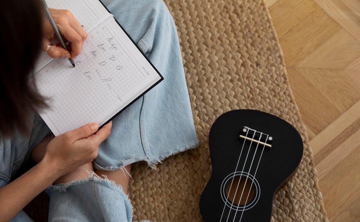 Cute woman composing a new song on ukulele