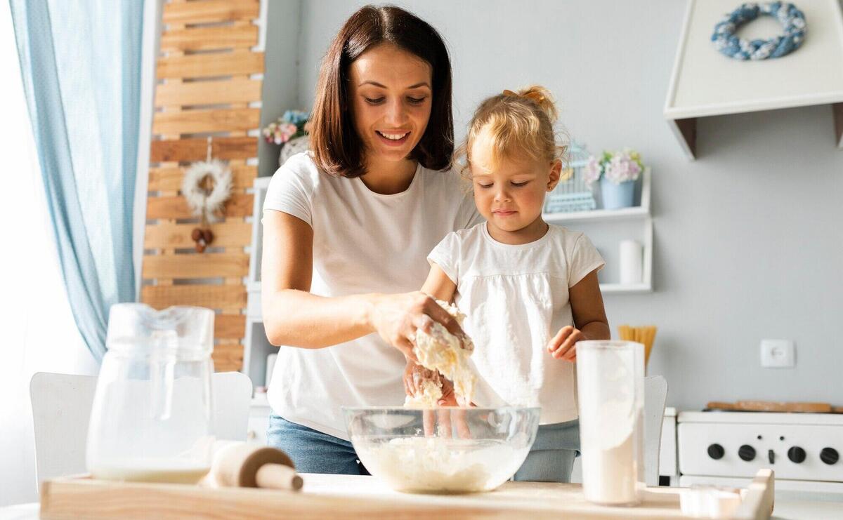 Mother and daughter preparing dough