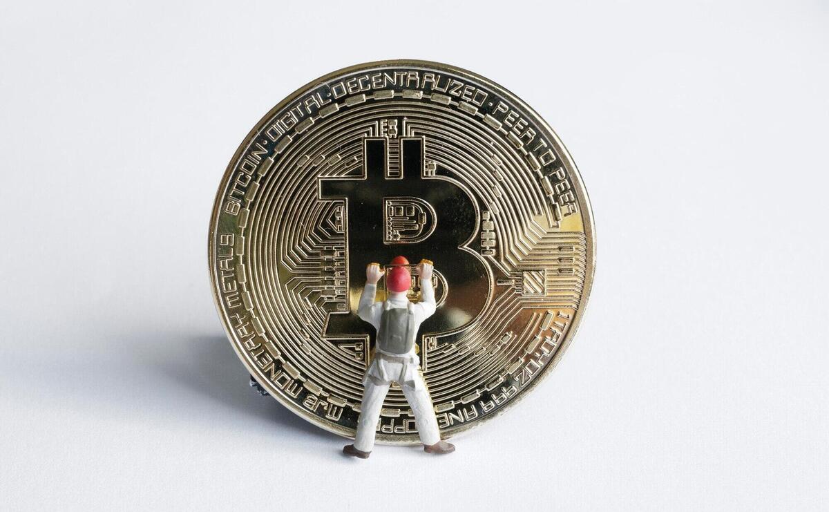 Macro miner figures working on bitcoin. virtual cryptocurrency mining concept