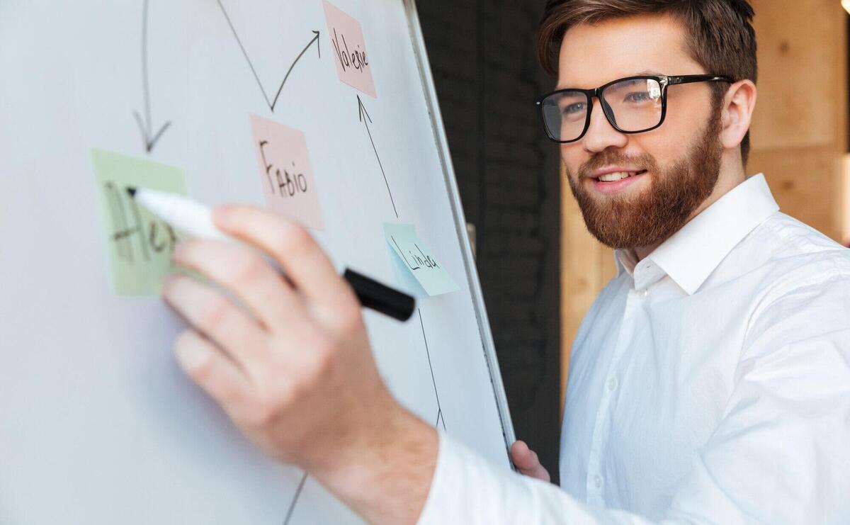 Cheerful young businessman write something