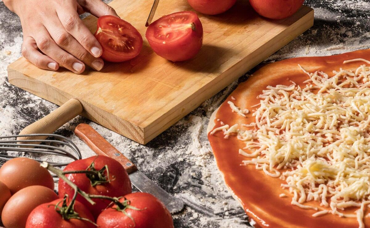 High angle hands cutting tomato