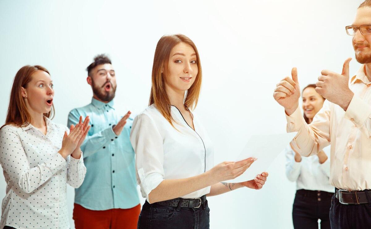 Boss approving and congratulating young successful employee