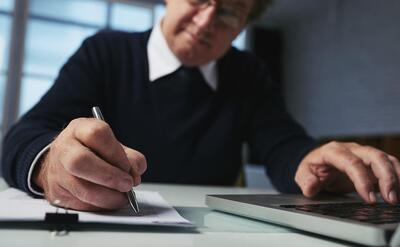 Low angle view of man writing down ideas